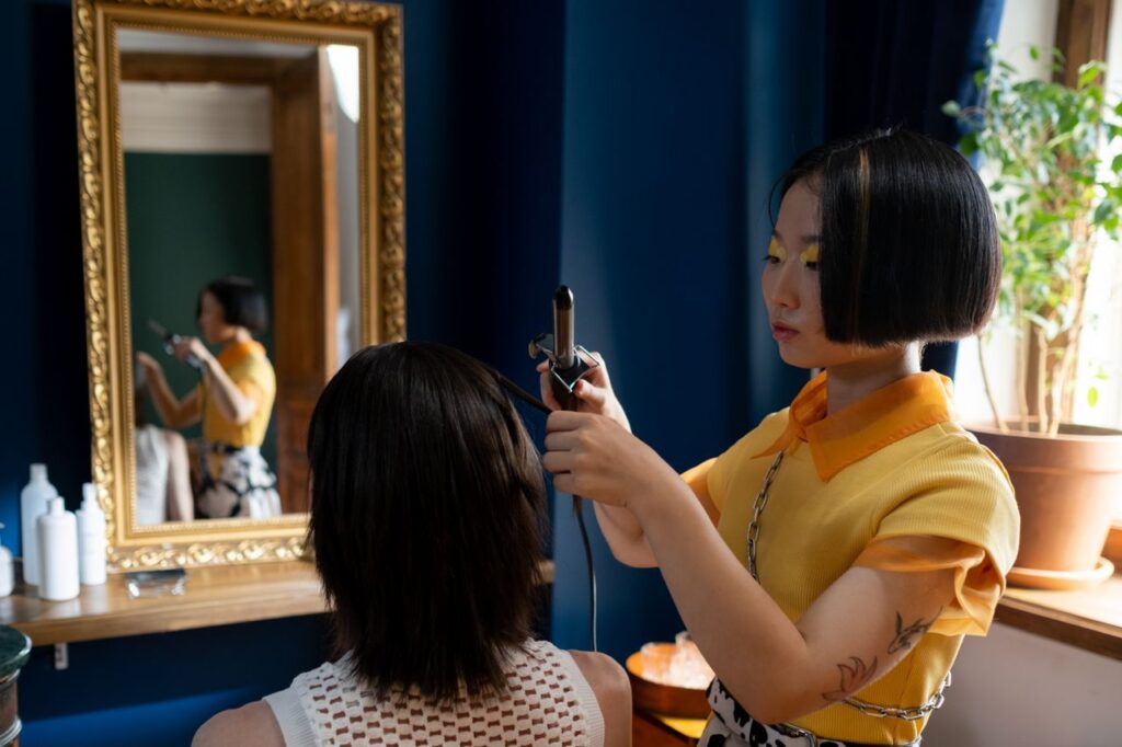 Crafting Captivating Headlines: Your awesome post title goes here Hairdresser styling client's hair in a chic salon with a focus on detailed hair work.