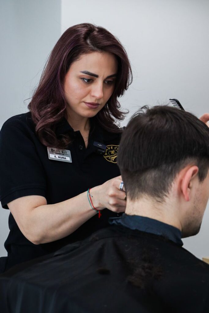 Mastering the First Impression: Your intriguing post title goes here A skilled hairdresser expertly cutting a client's hair in a salon setting.
